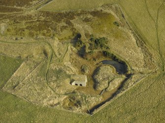 Oblique aerial view centred on the remains of the lime kiln, taken from the WNW.