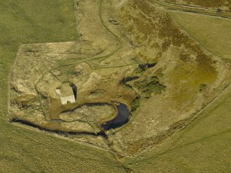 Oblique aerial view centred on the remains of the lime kiln, taken from the SSW.