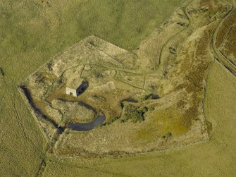 Oblique aerial view centred on the remains of the lime kiln, taken from the N.