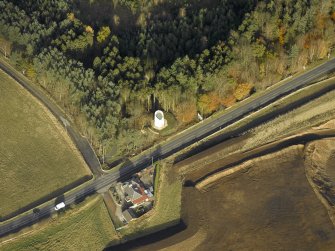 Oblique aerial view centred on the remains of the windmill, taken from the SW.