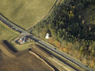 Oblique aerial view centred on the remains of the windmill, taken from the SE.