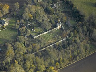 Oblique aerial view centred on the tower and burial ground, taken from the W.