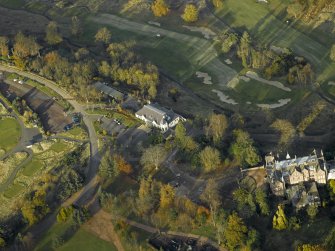 Oblique aerial view centred on the clubhouse with the house adjacent, taken from the S.