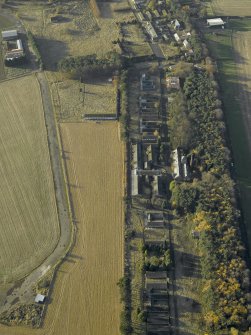 Oblique aerial view centred on the former hospital with East Fortune farmstead adjacent, taken from E.