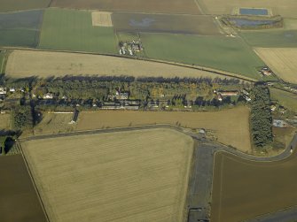 General oblique aerial view centred on the former hospital with East Fortune farmstead adjacent, taken from S.