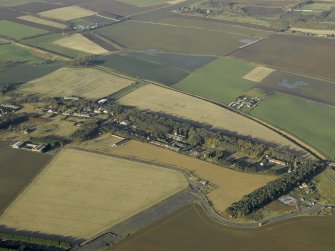 General oblique aerial view centred on the former hospital with East Fortune farmstead adjacent, taken from SE.