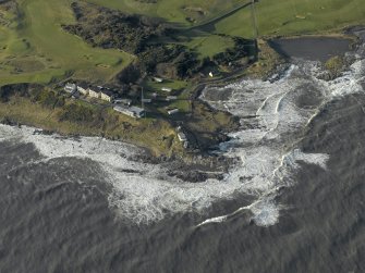 Oblique aerial view centred on Fife Ness Lighthouse with an airfield defence pillbox adjacent, taken from the East.