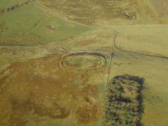 Oblique aerial view centred on the remains of the settlement, taken from the SE.