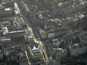 Oblique aerial view centred on new construction work at the junction of High Street and George IV Bridge, taken from the N.