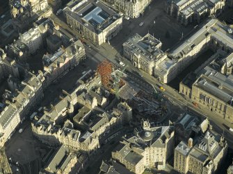 Oblique aerial view centred on new construction work at the junction of High Street and George IV Bridge, taken from the SW.