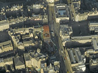 Oblique aerial view centred on new construction work at the junction of High Street and George IV Bridge, taken from the S.