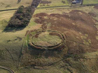 Oblique aerial view centred on the remains of the settlement, taken from the NW.