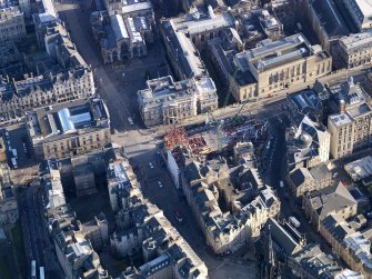 Oblique aerial view centred on new construction work at the junction of High Street and George IV Bridge, taken from the W.