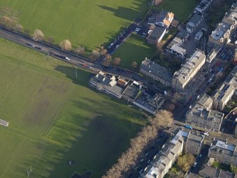 Oblique aerial view centred on the the rugby pavilion, taken from the SW.