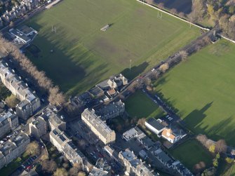 Oblique aerial view centred on the the rugby pavilion, taken from the SE.