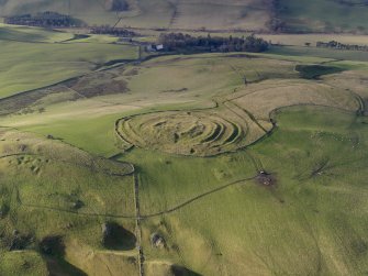 Oblique aerial view centred on the remains of the fort and linear earthwork, taken from the ENE.