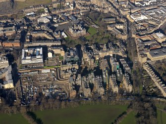 Oblique aerial view centred on the former Royal Infirmary buildings (now Quartermile), taken from the SW.