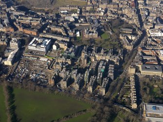 Oblique aerial view centred on the former Royal Infirmary buildings (now Quartermile), taken from the WSW.