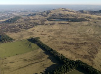 General oblique aerial view centred on the remains of rig and furrow cultivation on the NW-facing slopes of the Petlands, taken from the W.