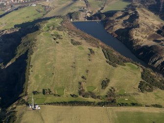 Oblique aerial view centred on the golf course and remains of  rig and furrow cultiavtion with the reservoir adjacent, taken from the W.