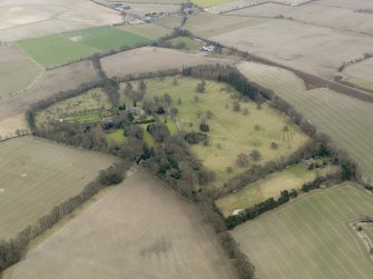 General oblique aerial view centred on the tower house with the remains of the rig and furrow adjacent, taken from the NW.