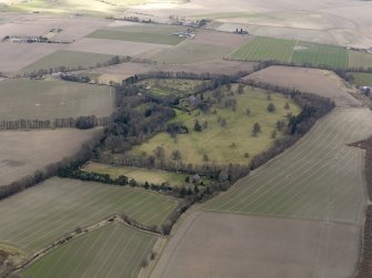 General oblique aerial view centred on the tower house with the remains of the rig and furrow adjacent, taken from the SW.