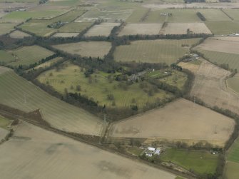 General oblique aerial view centred on the tower house with the remains of the rig and furrow adjacent, taken from the SE.