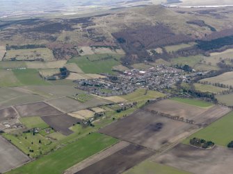 General oblique aerial view centred on the field boundaries with the golf course and town adjacent, taken from the NE.