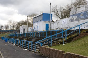 View of S terracing from W showing scoreboard and press box..