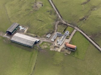 Oblique aerial view centred on the remains of the farmstead/grange with the later farmstead adjacent, taken from the NNW.