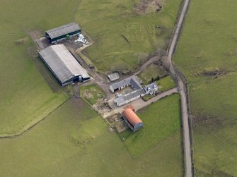 Oblique aerial view centred on the remains of the farmstead/grange with the later farmstead adjacent, taken from the NW.