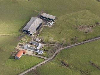 Oblique aerial view centred on the remains of the farmstead/grange with the later farmstead adjacent, taken from the W.