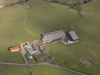 Oblique aerial view centred on the remains of the farmstead/grange with the later farmstead adjacent, taken from the SW.