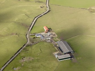 Oblique aerial view centred on the remains of the farmstead/grange with the later farmstead adjacent, taken from the SW.