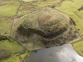 Oblique aerial view centred on the remains of a fort, taken from the NW.