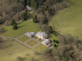 Oblique aerial view centred on the House with the coach house and stables adjacent, taken from the SE.