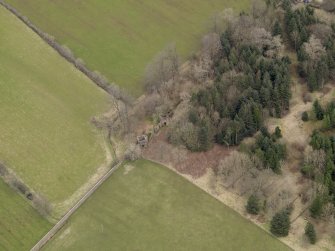 Oblique aerial view centred on the remains of the prisoner-of-war camp with The Temple adjacent, taken from the WSW.