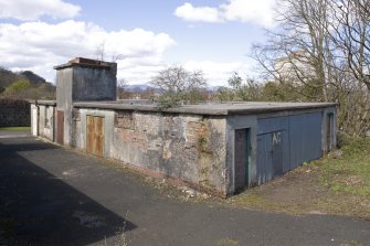 General view of N main building showing water tank on roof from SE.