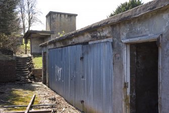 Detail.  E gable end of S main building showing doors and entrances from NE.