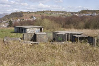 View.  Gun-emplacement with engine/generator house in background from W.