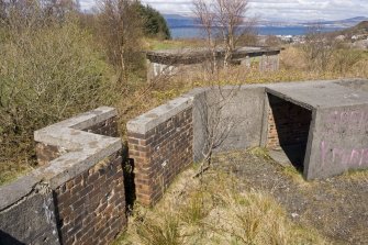 Detail.  Rear entrance to NW gun emplacement with blast wall, magazine in background.