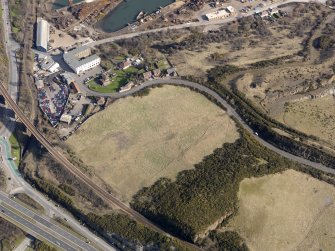 Oblique aerial view centered on the former golf course with the railway viaduct and building adjacent, taken from the SW.