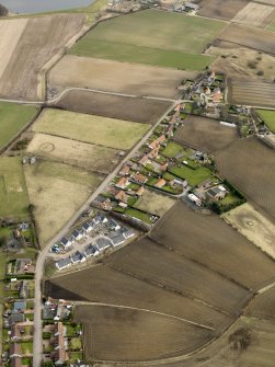 General oblique aerial view centred on the east end of the village, taken from the W.