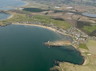 General oblique aerial view centred on the villages with the golf course and harbour adjacent, taken from the SE.