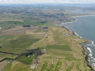 General oblique aerial view centred on the sewage works with the golf course, town, farmhouse, farmsteading and house adjacent, taken from the ESE.