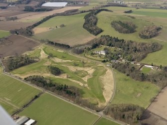 General oblique aerial view centred on the golf course with the country house, dovecot, stable, lodge, and cottage adjacent, taken from the SE.
