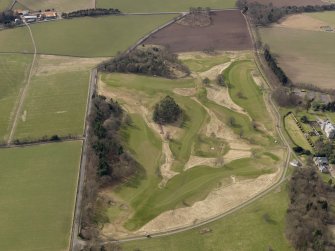 Oblique aerial view centred on the golf course with the country house, dovecot, stable and lodge adjacent, taken from the ENE.