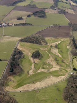 Oblique aerial view centred on the golf course with the dovecot and lodge adjacent, taken from the ENE.