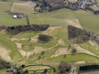 Oblique aerial view centred on the golf course with the dovecot, stable and lodge adjacent, taken from the NNW.