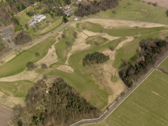 Oblique aerial view centred on the golf course with the dovecot, cottage, lodge and stable adjacent, taken from the SSW.